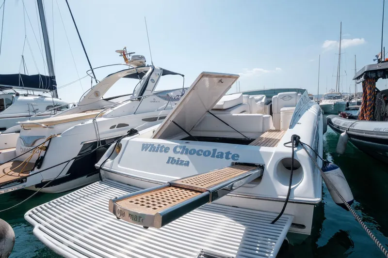 White Chocolate Yacht Photos Pics 2003 Magnum 44 yacht named "White Chocolate" docked in Ibiza marina.