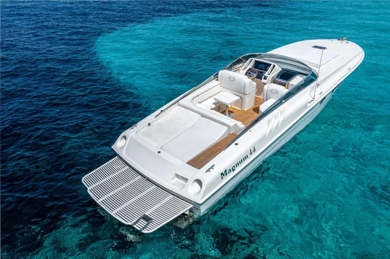 White Chocolate Yacht Photos Pics Luxury Magnum 44 speedboat from 2003 on clear blue ocean water.