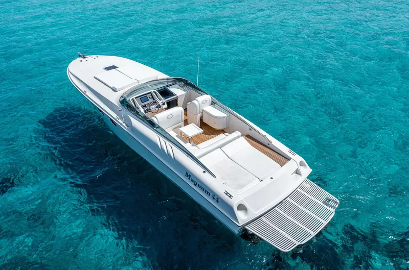 White Chocolate Yacht Photos Pics 2003 Magnum 44 boat on clear blue water, aerial view.