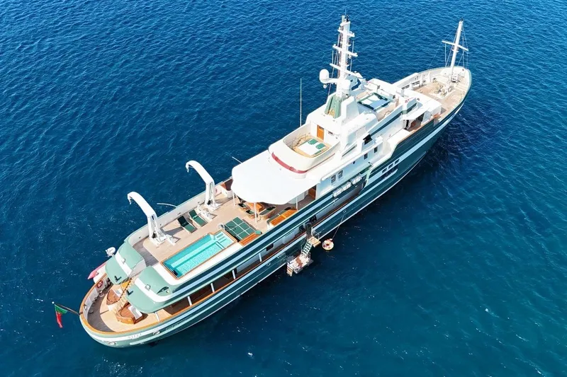 Steel Yacht Photos Pics Luxurious 2009 Pendennis 55 yacht with pool, cruising in clear blue ocean waters.