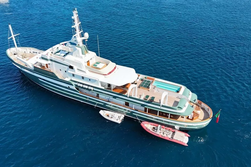 Steel Yacht Photos Pics Luxurious 2009 Pendennis 55 yacht with pool, anchored in clear blue ocean.