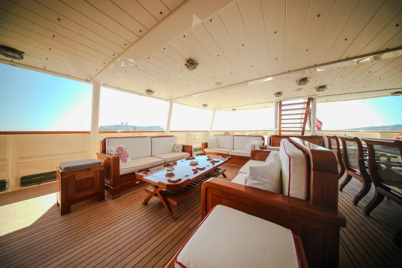 Steel Yacht Photos Pics Luxurious Pendennis 55 yacht deck with elegant seating, wooden flooring, and ocean view, 2009 model.