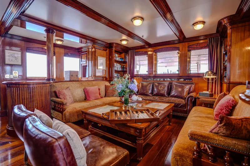 Steel Yacht Photos Pics Luxurious Pendennis 55 yacht interior, 2009 model, featuring elegant wood paneling and plush seating.