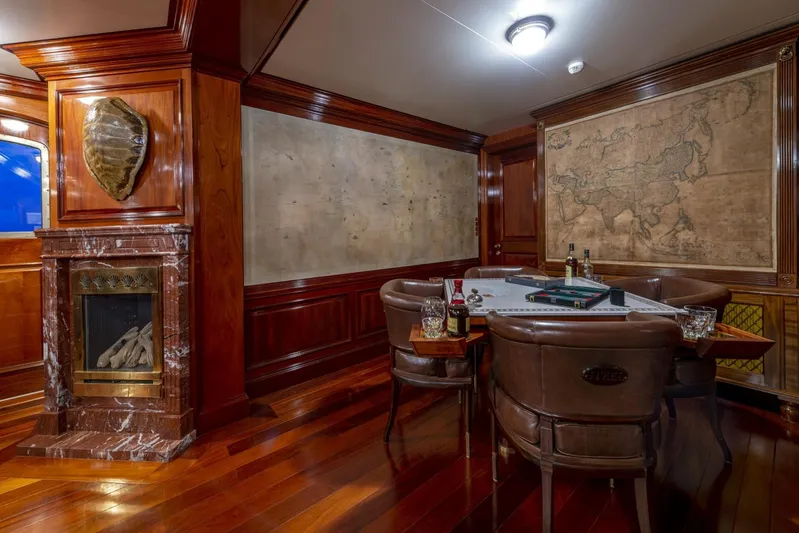 Steel Yacht Photos Pics Luxurious yacht interior with leather chairs, wooden paneling, and a vintage map, Pendennis 55, 2009.