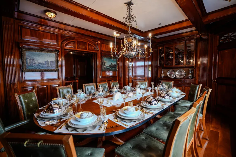 Steel Yacht Photos Pics Luxurious dining room on Pendennis 55 yacht, 2009, with elegant table setting and chandelier.