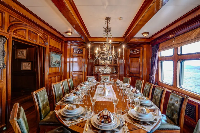 Steel Yacht Photos Pics Luxurious dining room on Pendennis 55 yacht, 2009, with elegant wood paneling and opulent table setting.