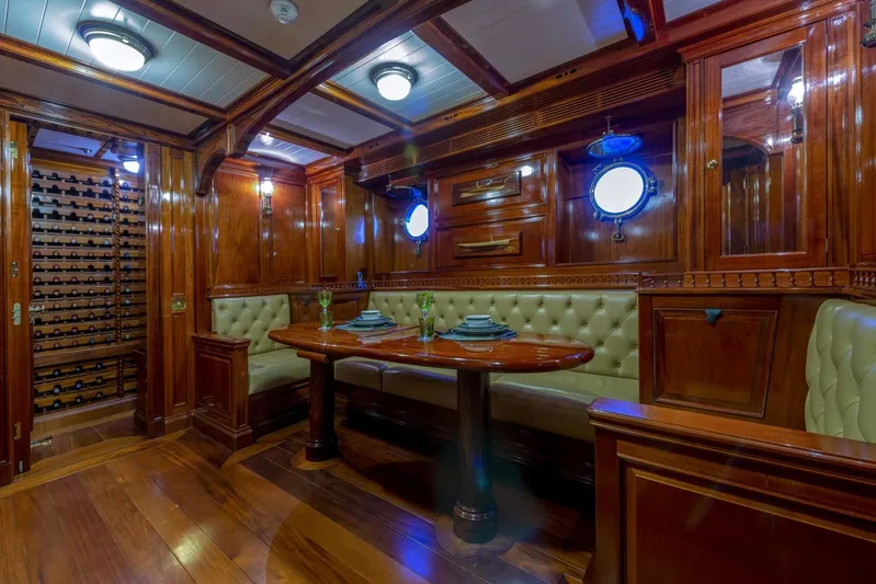 Steel Yacht Photos Pics Luxurious wooden interior of 2009 Pendennis 55 yacht with elegant dining area and wine storage.
