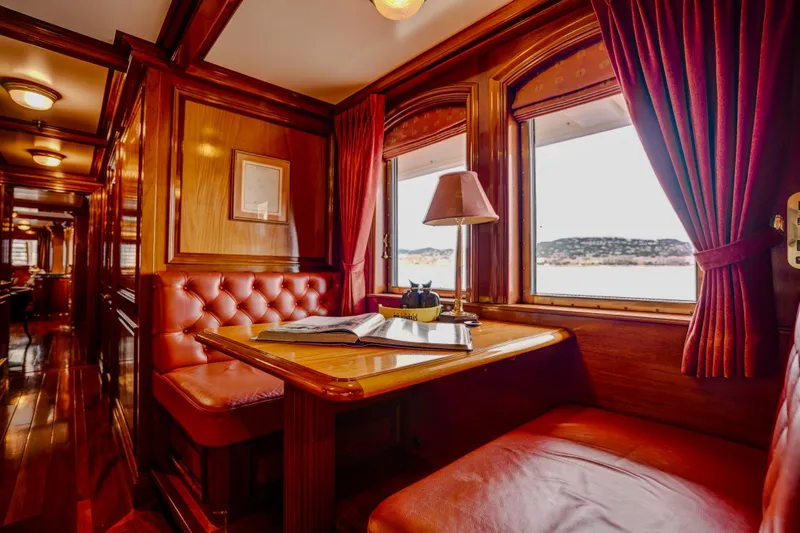 Steel Yacht Photos Pics Luxurious Pendennis 55 yacht interior, 2009 model, featuring elegant wood paneling and plush seating.