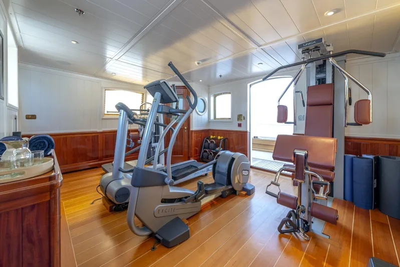 Steel Yacht Photos Pics Luxurious gym on 2009 Pendennis 55 yacht with modern exercise equipment and wooden flooring.