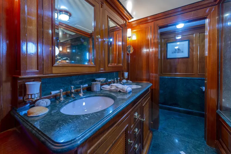 Steel Yacht Photos Pics Luxurious bathroom with wooden cabinetry and marble countertops on a 2009 Pendennis 55 yacht.