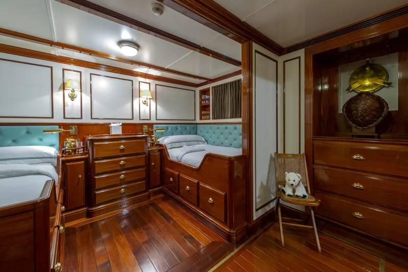 Steel Yacht Photos Pics Luxurious Pendennis 55 yacht cabin interior, 2009 model, featuring elegant wood furnishings and plush bedding.