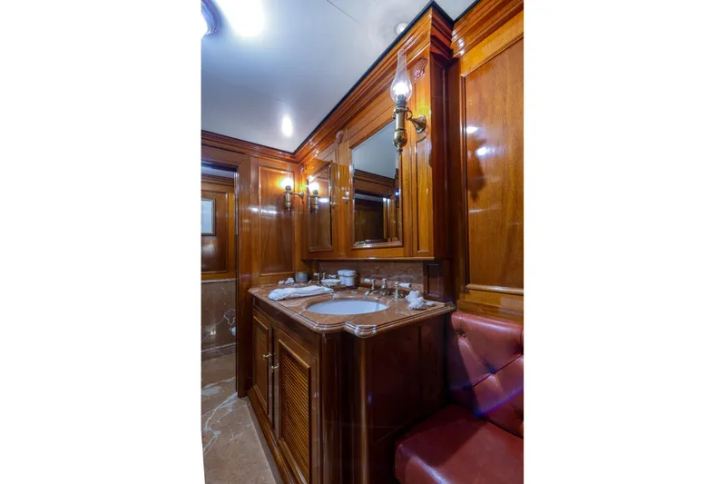 Steel Yacht Photos Pics Luxurious wooden bathroom interior on 2009 Pendennis 55 yacht, featuring elegant fixtures and lighting.