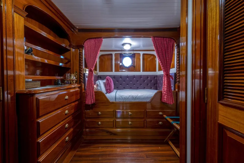Steel Yacht Photos Pics Luxurious Pendennis 55 yacht cabin, 2009 model, featuring elegant woodwork and plush bedding.