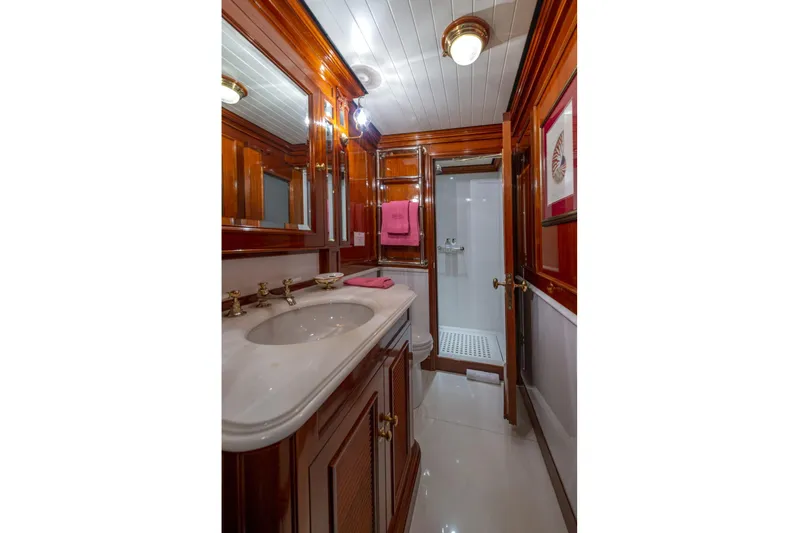 Steel Yacht Photos Pics Luxurious bathroom in 2009 Pendennis 55 yacht, featuring elegant wood paneling and modern fixtures.