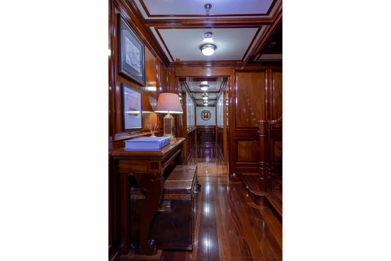 Steel Yacht Photos Pics Luxurious wooden interior of 2009 Pendennis 55 yacht, featuring elegant decor and ambient lighting.