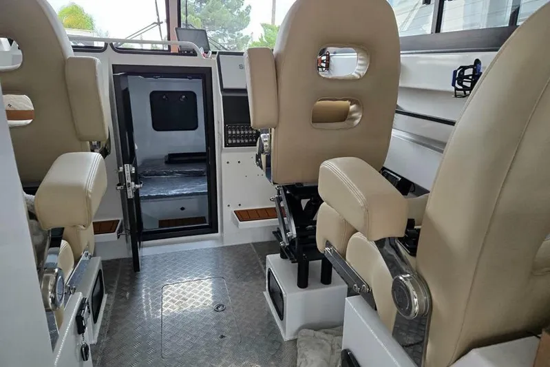 Yacht Photos Pics Interior of 2025 Custom Boat 34, featuring beige seats and modern design elements.