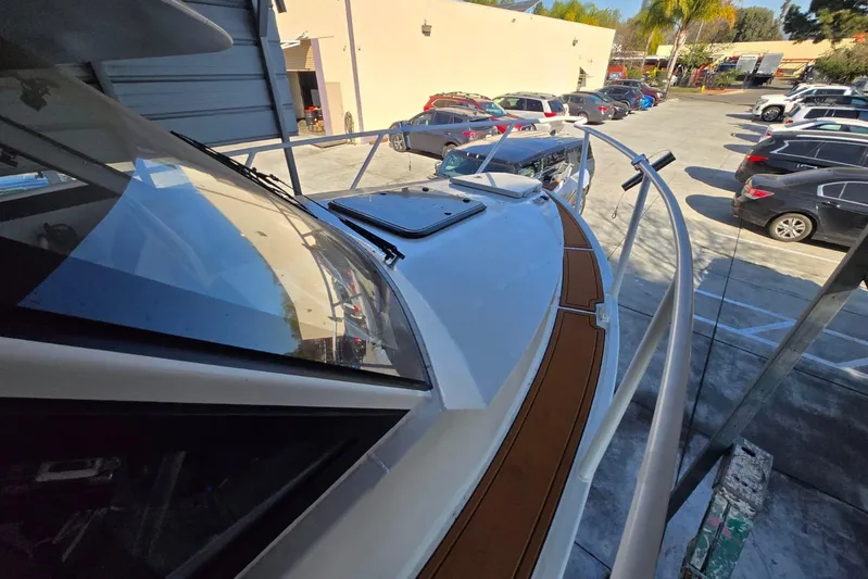  Yacht Photos Pics Custom Boat 34, 2025 model, docked in a parking lot with surrounding vehicles.
