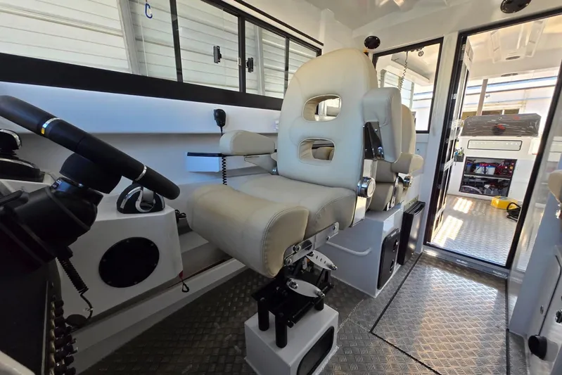  Yacht Photos Pics Interior of 2025 Custom Boat 34, featuring modern helm and comfortable seating.