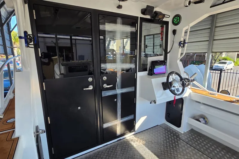  Yacht Photos Pics Interior of 2025 Custom Boat 34, featuring modern helm and sleek black doors.