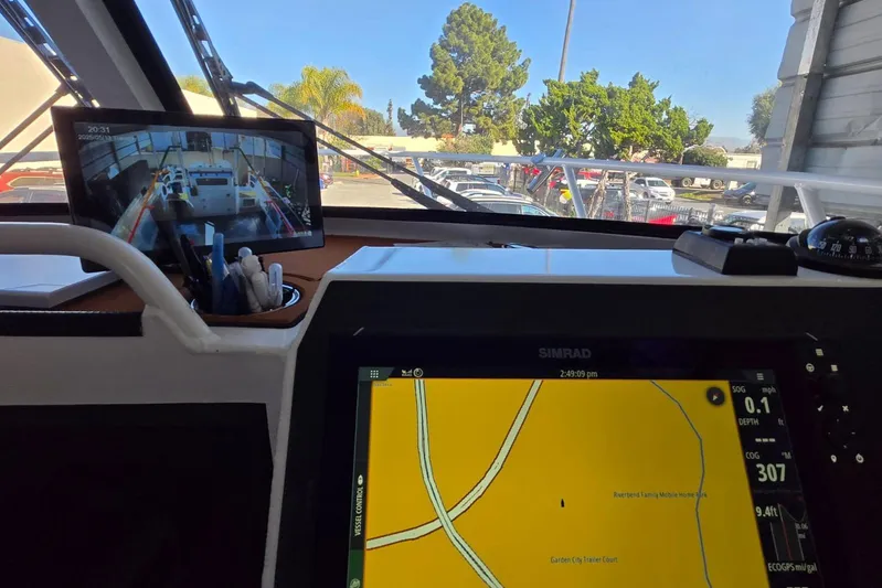  Yacht Photos Pics Interior view of a 2025 Custom Boat 34 with navigation screens and outdoor scenery.