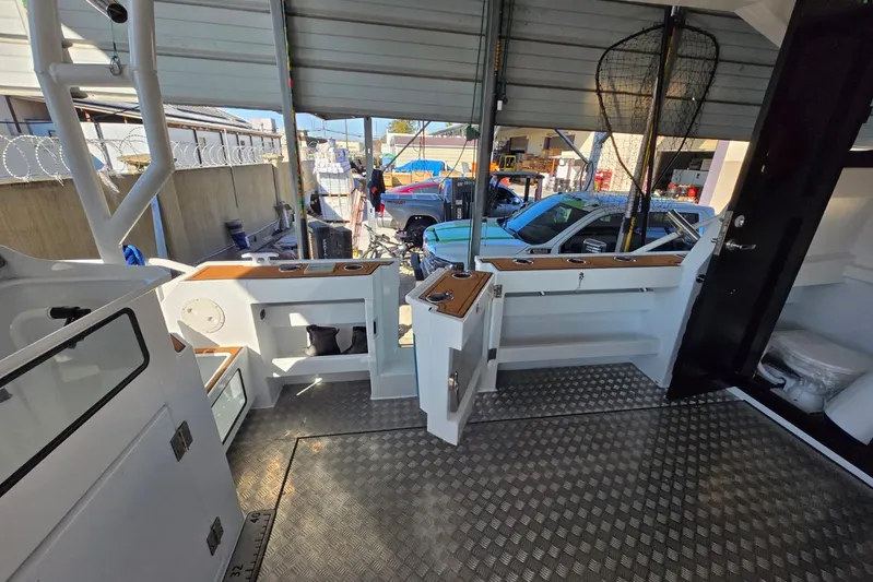  Yacht Photos Pics Custom Boat 34 (2025) interior with fishing gear and storage compartments.