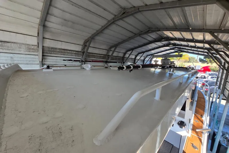  Yacht Photos Pics Custom Boat 34 (2025) under metal shelter, showcasing roof and equipment.