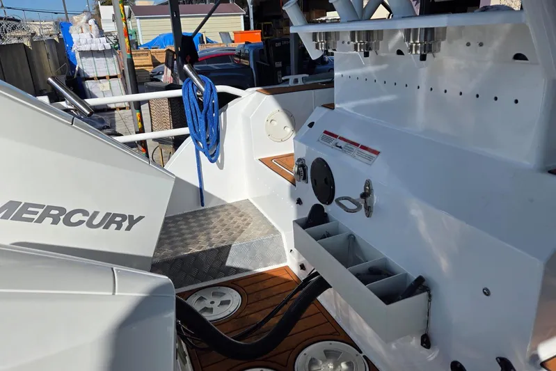  Yacht Photos Pics Custom Boat 34 (2025) with Mercury engine, featuring deck storage and blue rope.