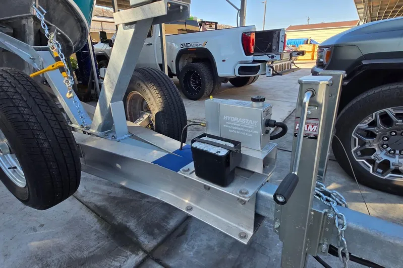  Yacht Photos Pics Trailer with Hydrastar brake actuator, Custom Boat 34, 2025 model, parked near trucks.