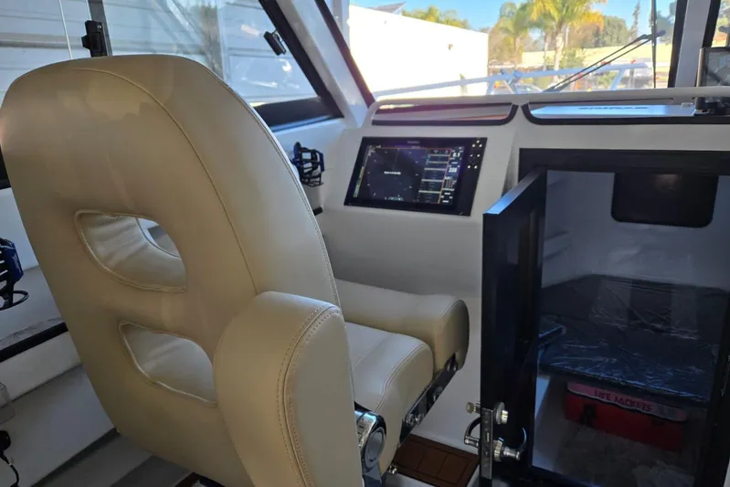  Yacht Photos Pics Interior of 2025 Custom Boat 34 with beige seating and modern navigation system.