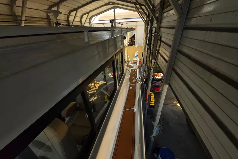  Yacht Photos Pics Custom Boat 34 (2025) docked in a covered marina, showcasing sleek design and modern features.