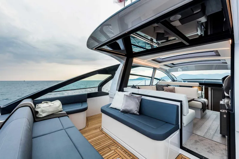 Dolcevita Yacht Photos Pics Luxurious 2022 Pershing 5x yacht interior with sleek seating and ocean view.
