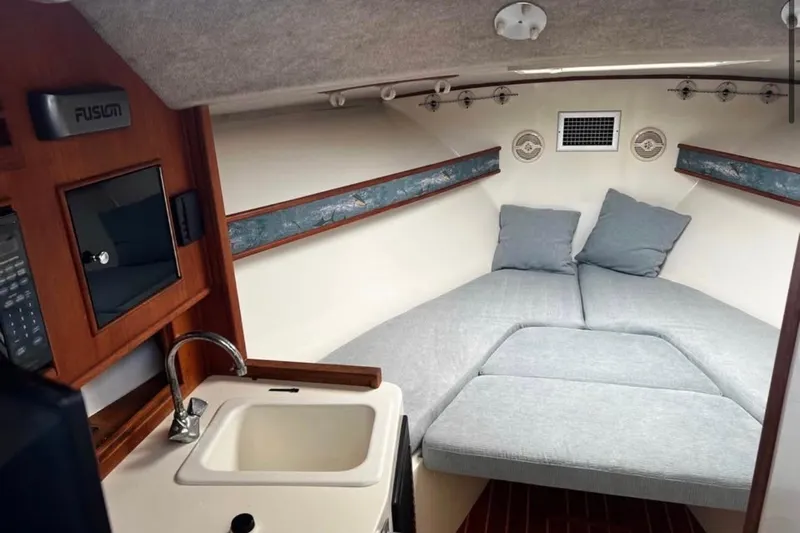  Yacht Photos Pics Interior of 2005 Carolina Classic 28 boat with cozy cabin and sink.
