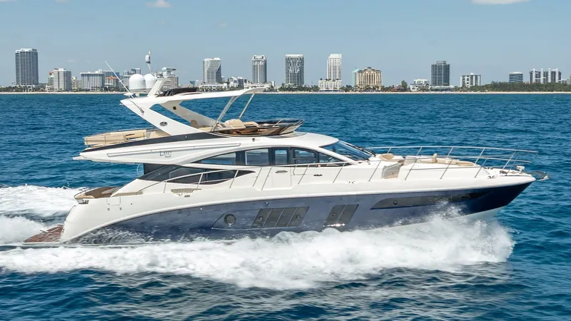  Yacht Photos Pics 2016 Sea Ray L650 Fly yacht cruising on blue ocean with city skyline backdrop.