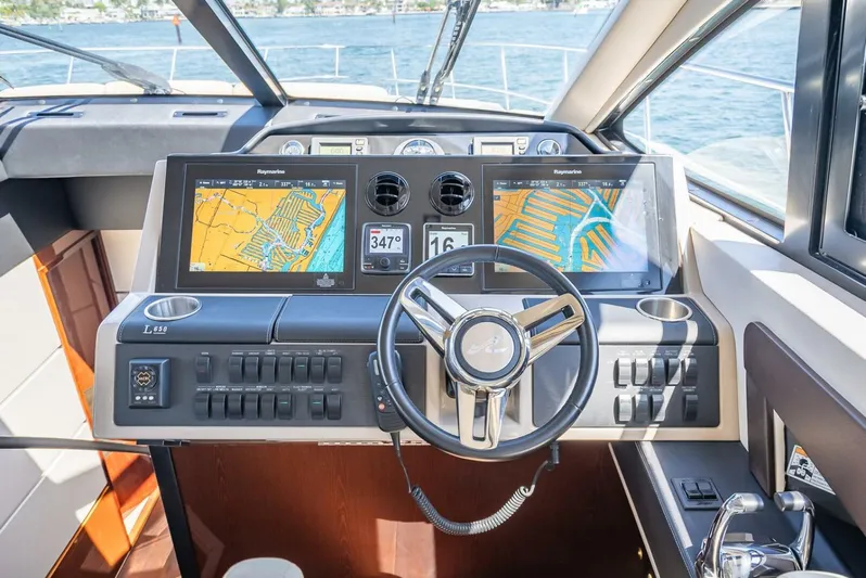  Yacht Photos Pics 2016 Sea Ray L650 Flybridge helm with dual navigation screens and modern controls.