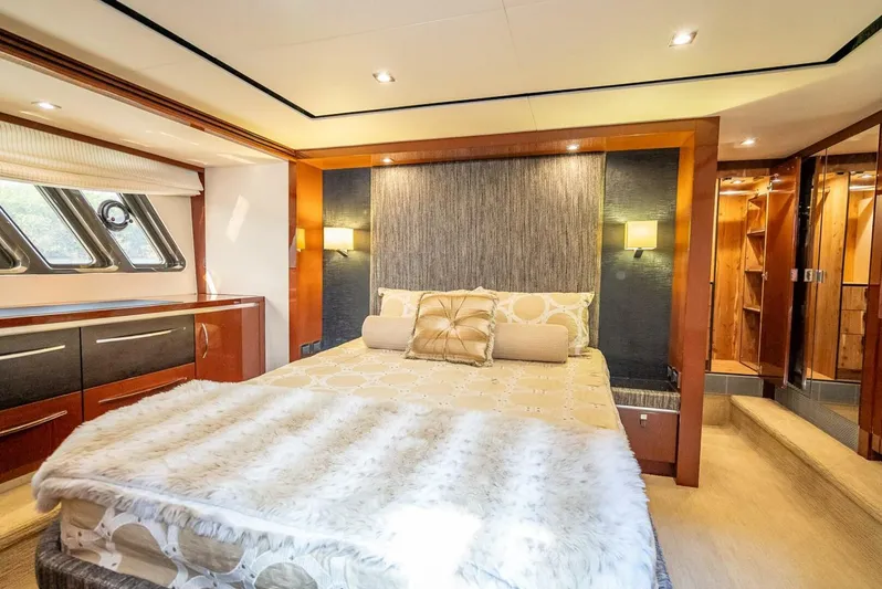  Yacht Photos Pics Luxurious bedroom interior of 2016 Sea Ray L650 Fly yacht with elegant decor and ample lighting.