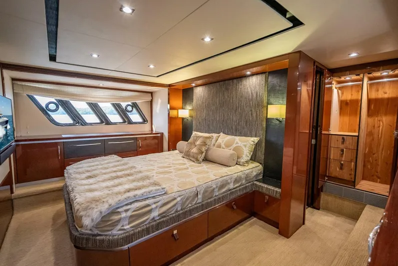  Yacht Photos Pics Luxurious bedroom interior of 2016 Sea Ray L650 Fly yacht with elegant wood finishes.