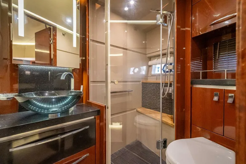  Yacht Photos Pics Luxurious bathroom in 2016 Sea Ray L650 Fly yacht with modern fixtures and elegant wood finishes.