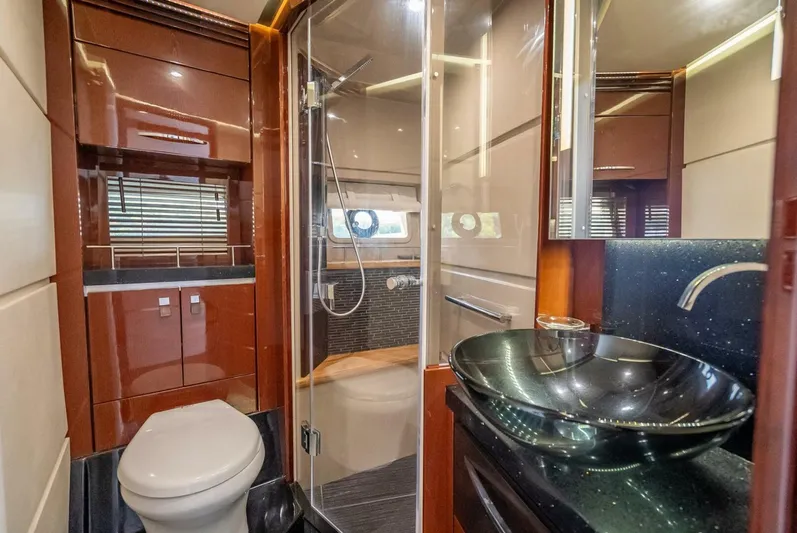  Yacht Photos Pics Luxurious bathroom in 2016 Sea Ray L650 Fly yacht with modern fixtures and glass shower.