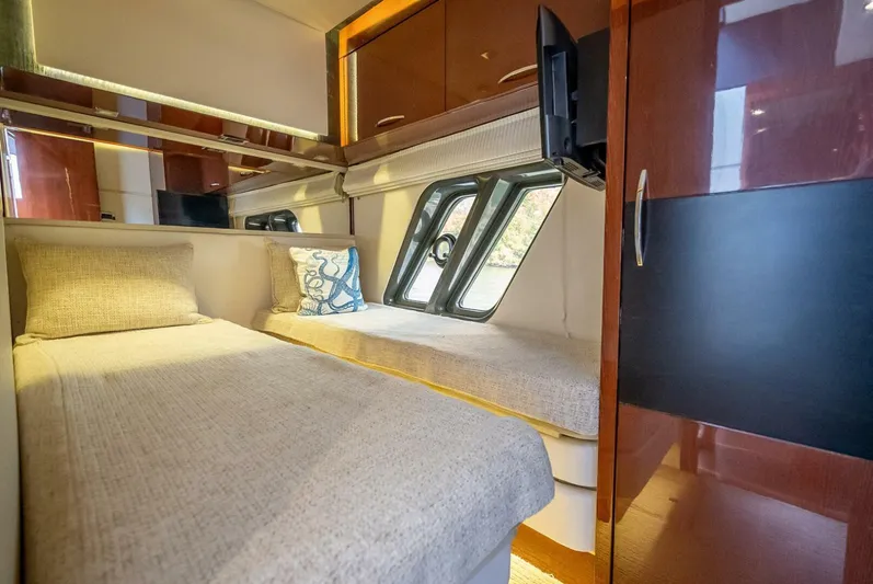  Yacht Photos Pics Luxurious cabin interior of 2016 Sea Ray L650 Fly yacht with twin beds and modern decor.