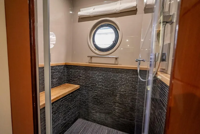  Yacht Photos Pics Luxurious bathroom interior of 2016 Sea Ray L650 Fly yacht with porthole and modern shower.