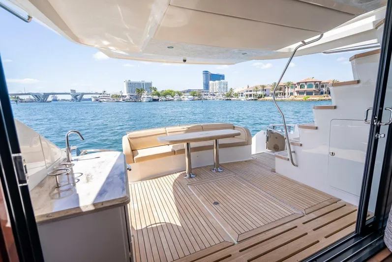  Yacht Photos Pics Luxurious 2016 Sea Ray L650 Fly yacht deck with seating, table, and waterfront view.