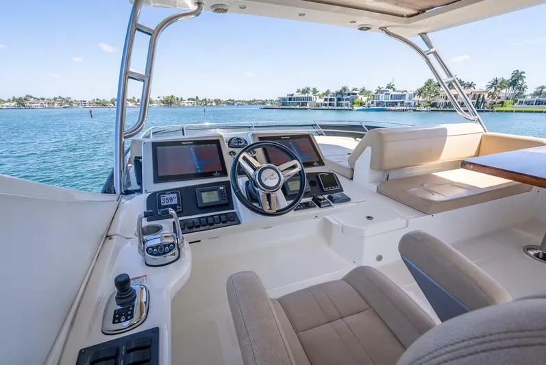  Yacht Photos Pics 2016 Sea Ray L650 Fly yacht helm with modern controls and waterfront view.
