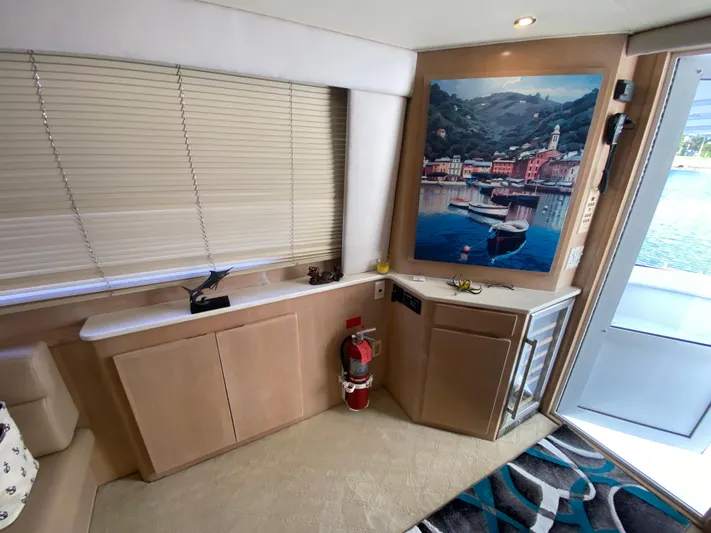 Mad East Yacht Photos Pics Interior of 1993 Hatteras 54 Convertible yacht with artwork and window blinds.