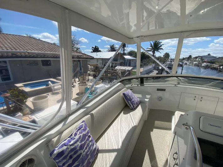 Mad East Yacht Photos Pics Interior view of 1993 Hatteras 54 Convertible yacht with waterfront scenery.