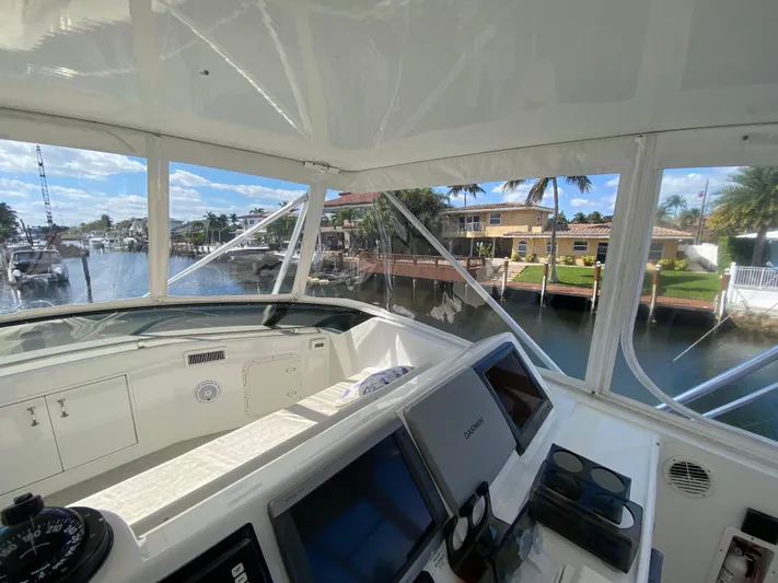 Mad East Yacht Photos Pics Interior view of 1993 Hatteras 54 Convertible yacht cockpit with navigation equipment.