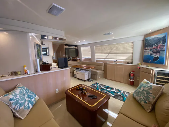 Mad East Yacht Photos Pics Luxurious interior of a 1993 Hatteras 54 Convertible yacht with modern furnishings.