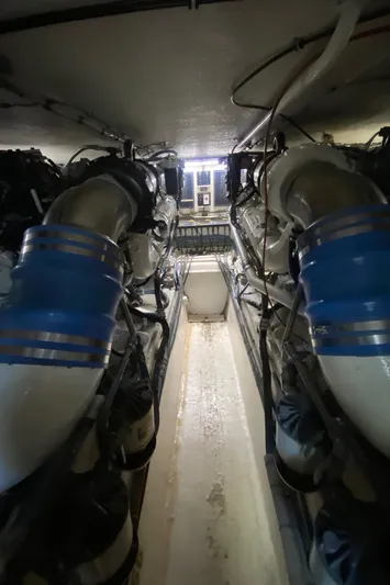 Mad East Yacht Photos Pics Engine room of 1993 Hatteras Convertible yacht with visible machinery and pipes.