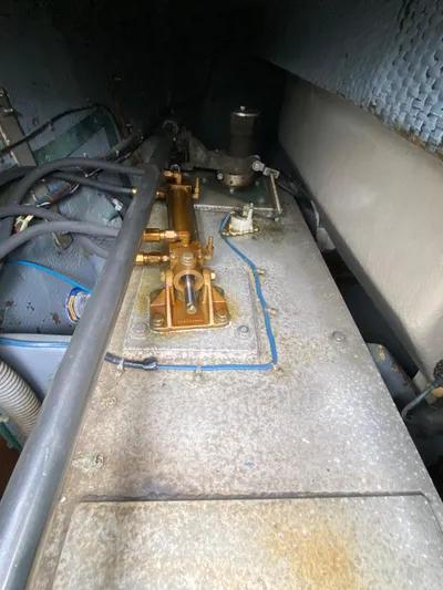 Mad East Yacht Photos Pics Engine room of a 1993 Hatteras Convertible boat, showing mechanical components and piping.