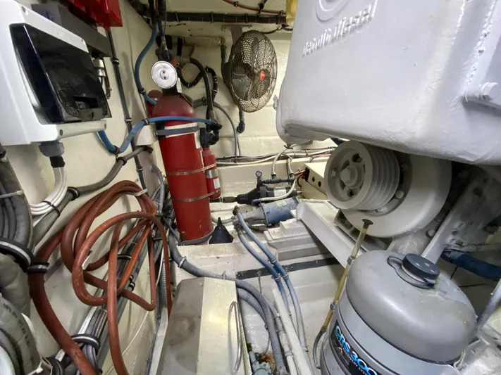 Mad East Yacht Photos Pics Engine room of 1993 Hatteras Convertible boat with equipment and wiring.