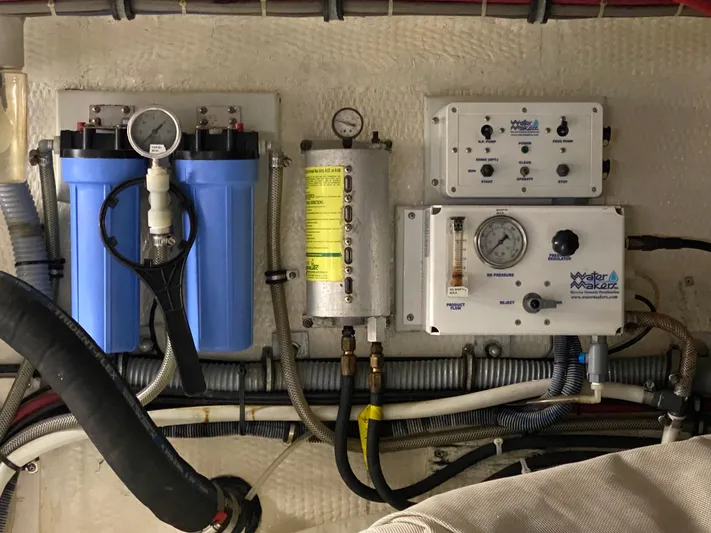 Mad East Yacht Photos Pics 1993 Hatteras Convertible engine room with water filtration system and control panels.